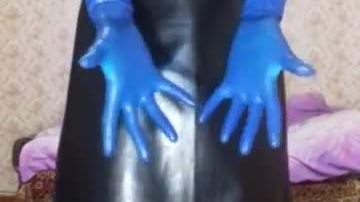 Guy in leather apron putting on different gloves